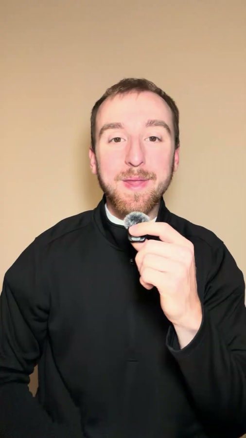On-camera piece: Sam talking to camera against a plain backdrop while clipping on a wireless mic