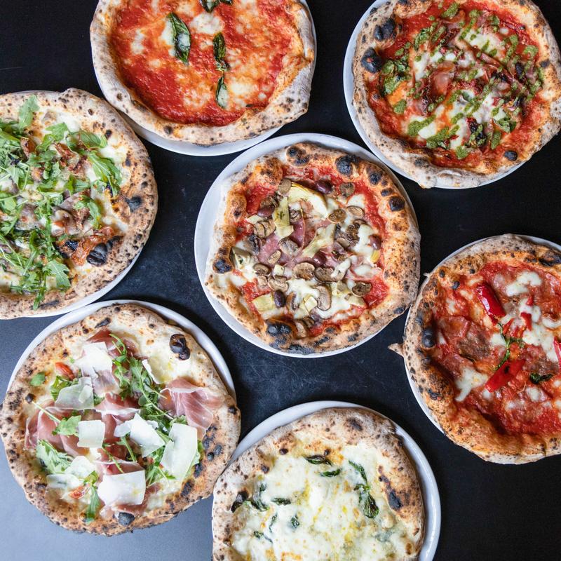 Assorted wood-fired pizzas, Bella Napoli Pizzeria