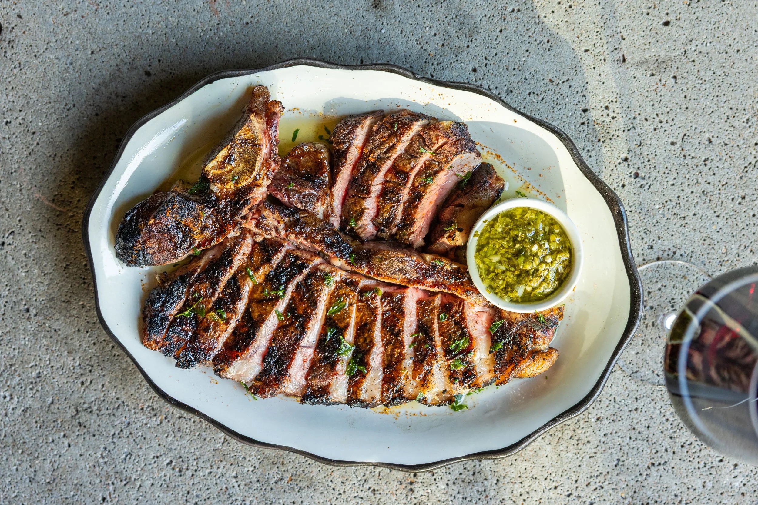 Sliced grilled steak with chimichurri, Butchertown Hall