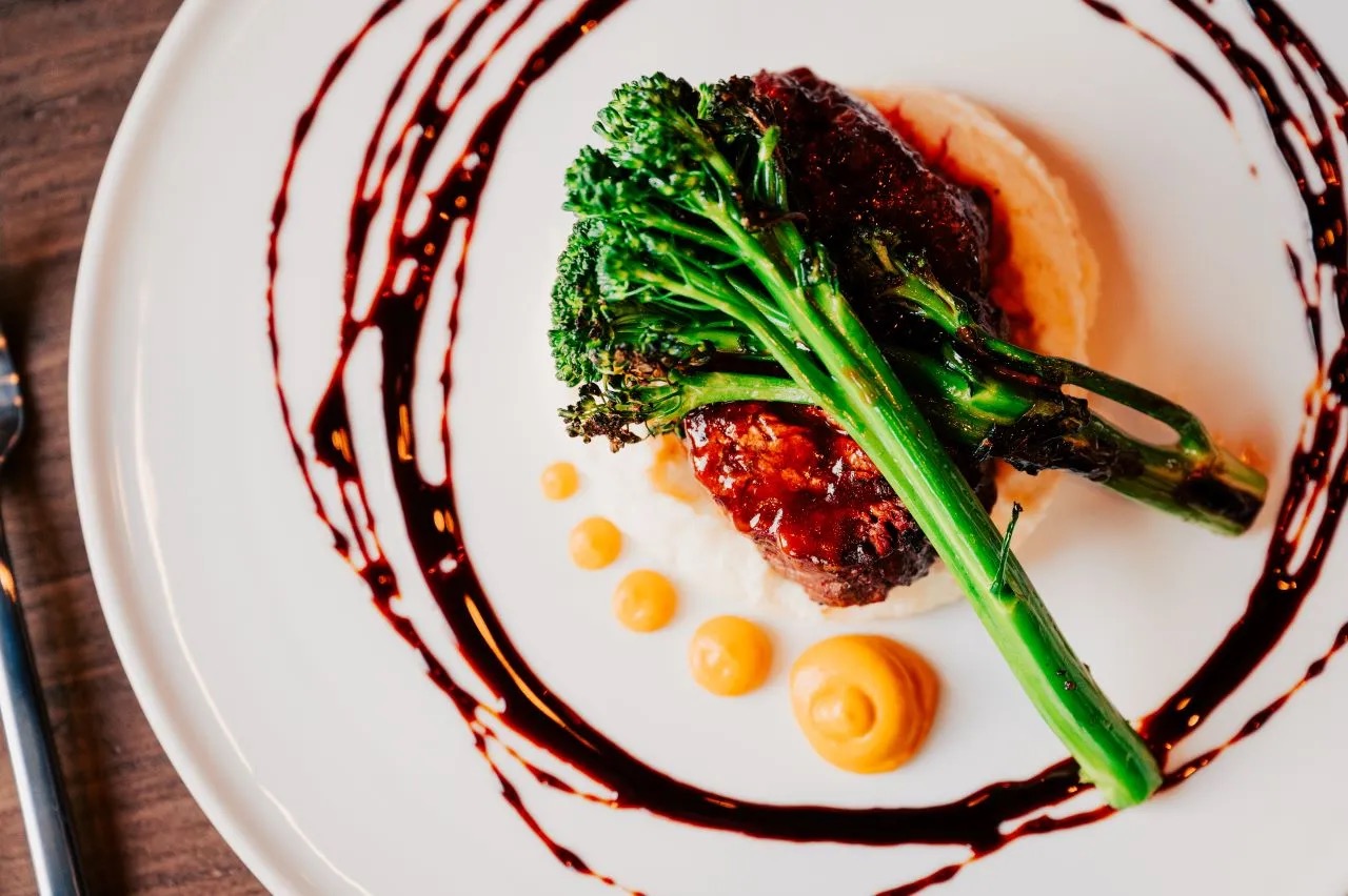 Plated entree with broccolini, Etch Nashville