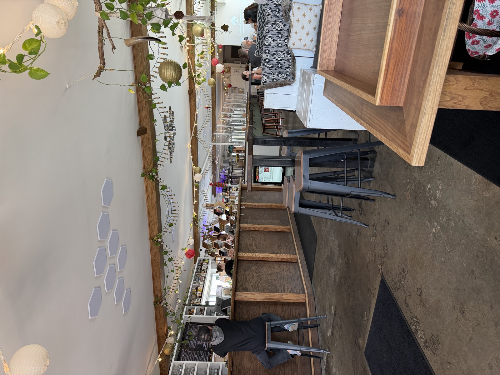 The bar next to the Bad Luck Burger Club trailer, with stools, string lights and hanging plants