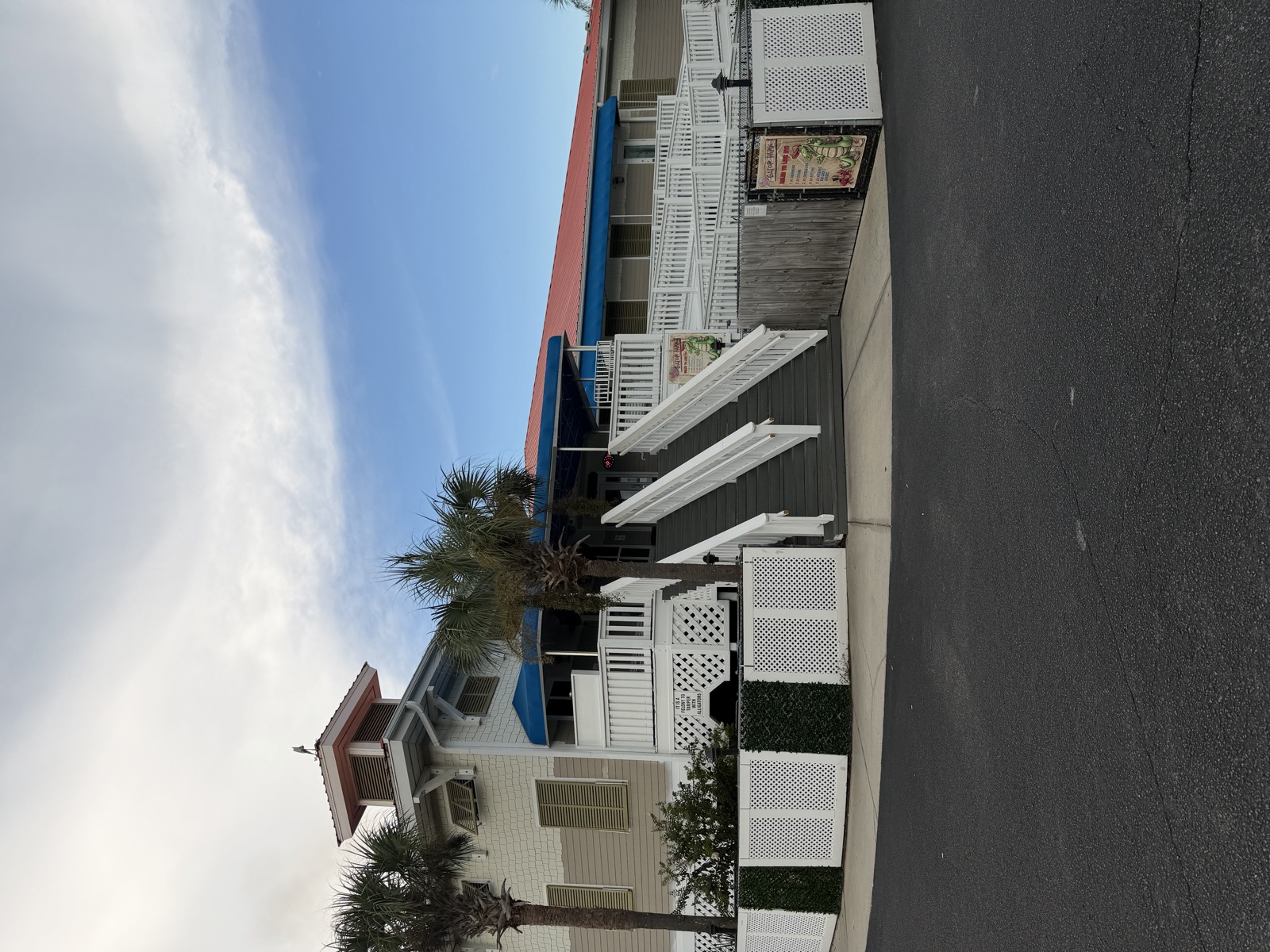 Bayou Bill's Crab House exterior on Front Beach Road, a raised white building with blue awnings and a wide staircase