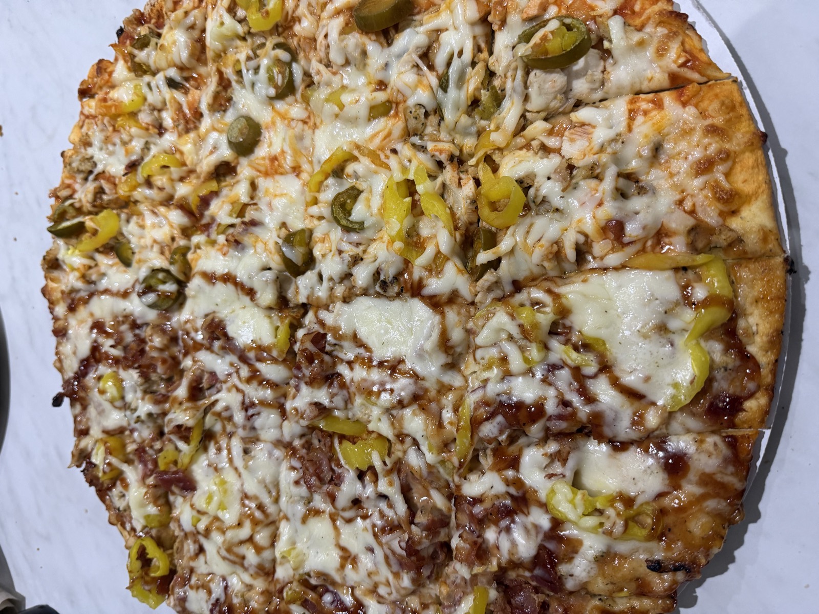 Sam's order: a 16-inch pizza, half Down The Chimney and half Founders Special, topped with banana peppers and jalapenos