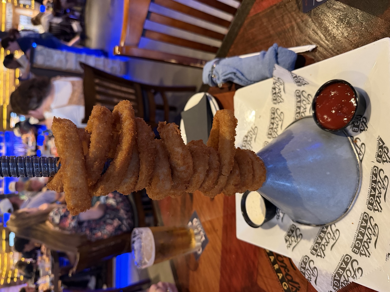 Sam's order: the Giant Funnel Tower of Piston Onion Rings with ranch and chipotle ketchup, Ford's Garage