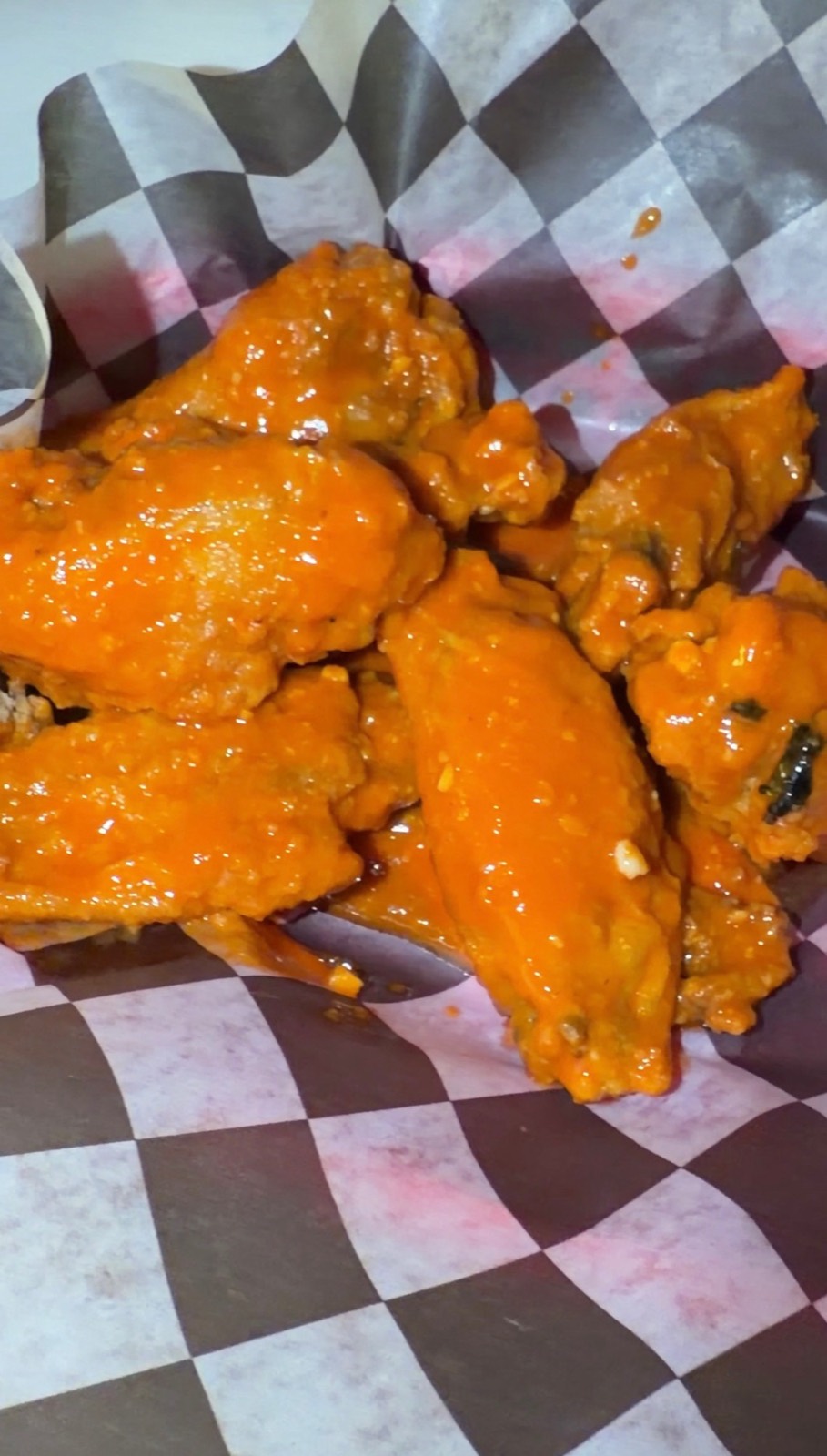 Sam's order: six buffalo wings in a checkered paper basket
