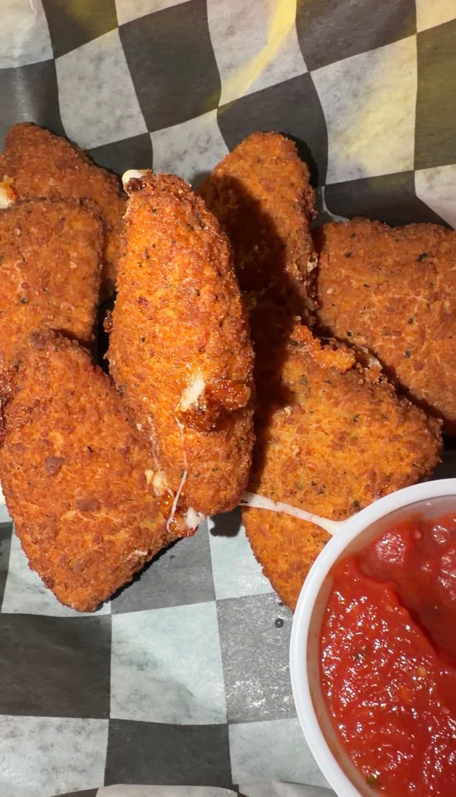 Sam's order: Fried Cheese Wedges pulling apart, with a cup of marinara