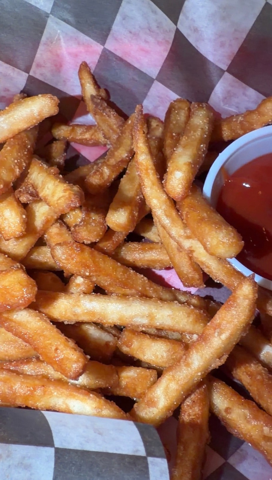 Sam's order: a basket of seasoned fries with ketchup