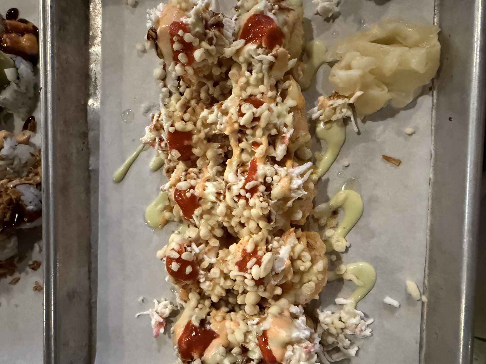 Sam's order: the Tempura Predators Roll, topped with crab, crunchy tempura bits and dots of sriracha