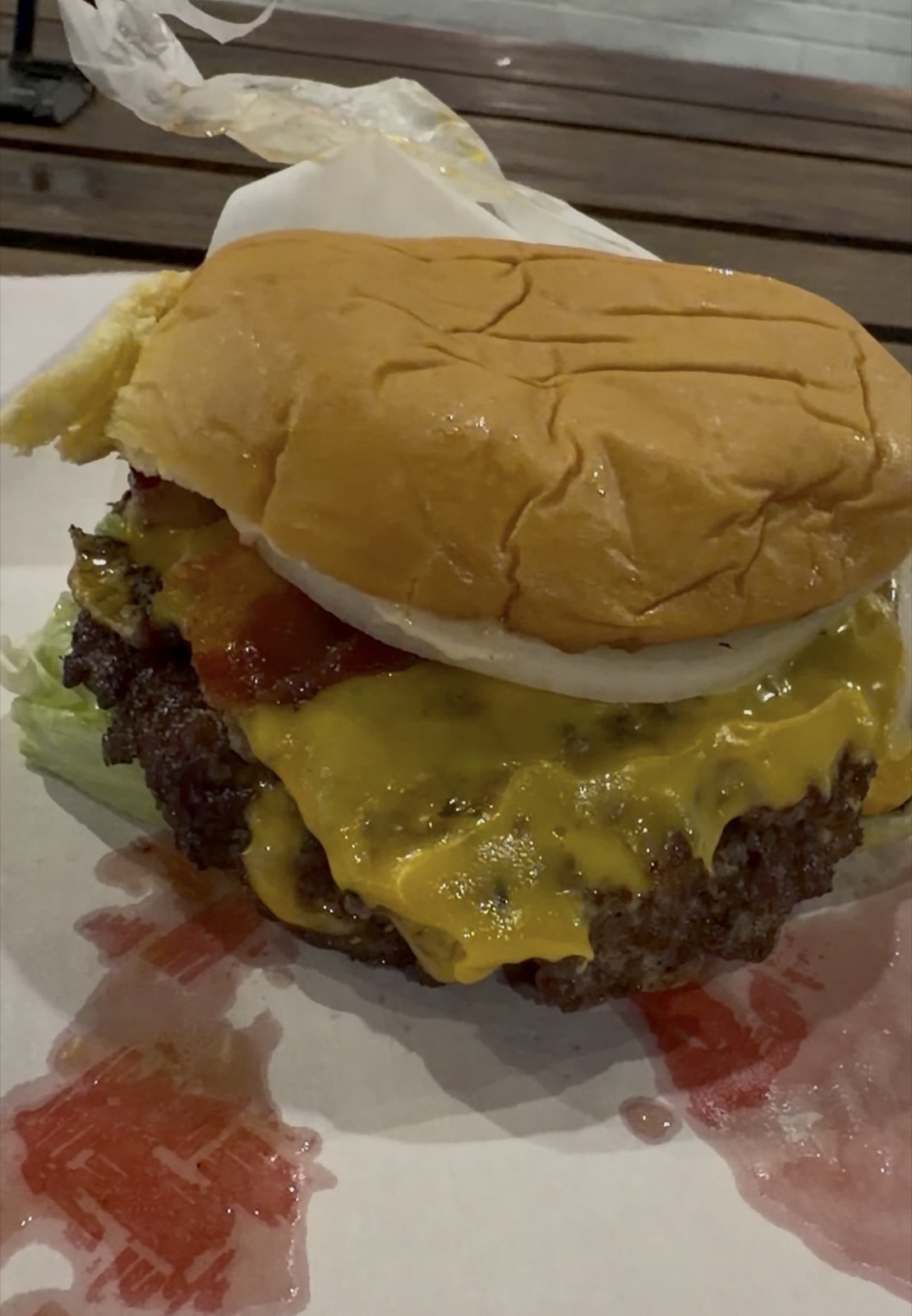 Close-up of the double cheeseburger, no pickle, add bacon, Hugh-Baby's