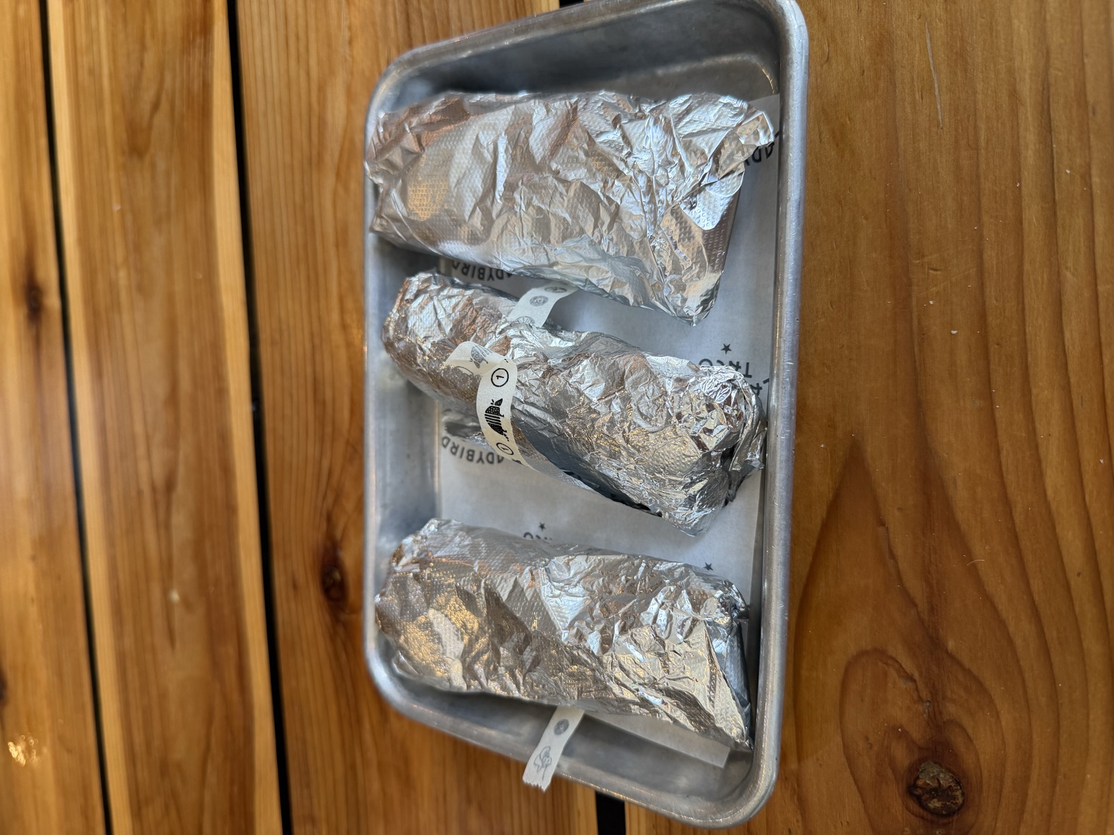 Sam's order: three foil-wrapped breakfast tacos, Ladybird Taco