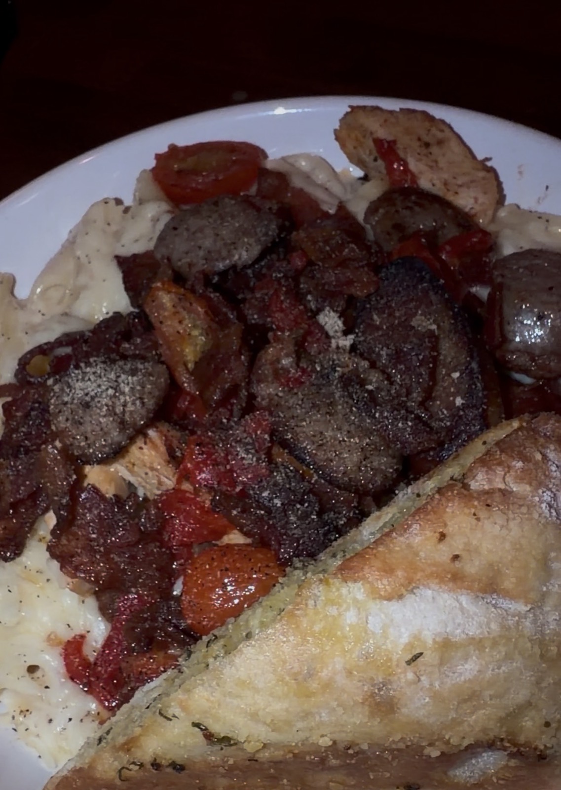 Sam's order: Pasta Rustica in cream sauce with sausage, bacon and tomatoes, with garlic bread, McGuire's Irish Pub