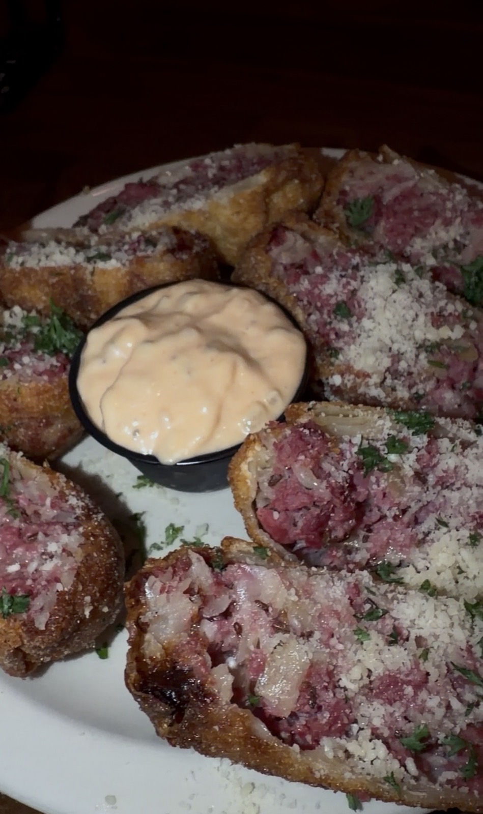 Sam's order: Reuben Egg Rolls sliced open around a cup of dipping sauce, McGuire's Irish Pub