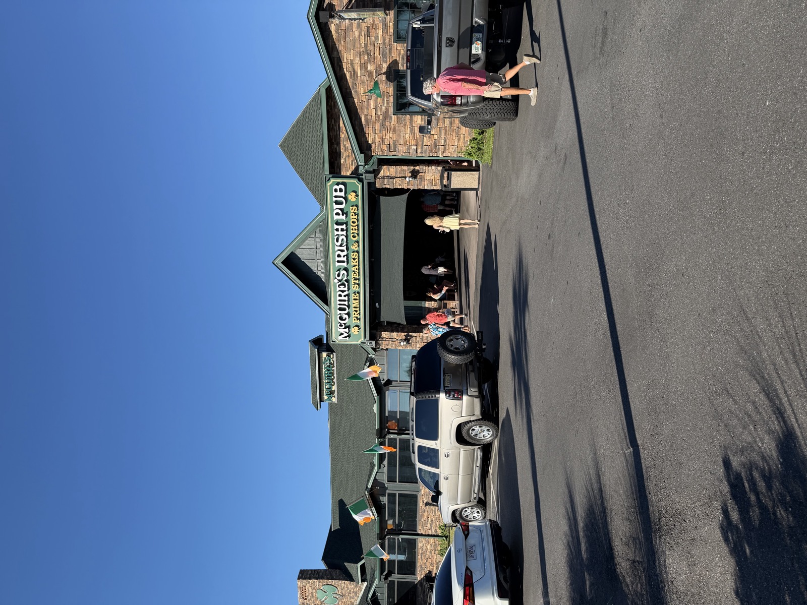 McGuire's Irish Pub entrance and parking lot, with Irish flags along the roofline, Panama City Beach