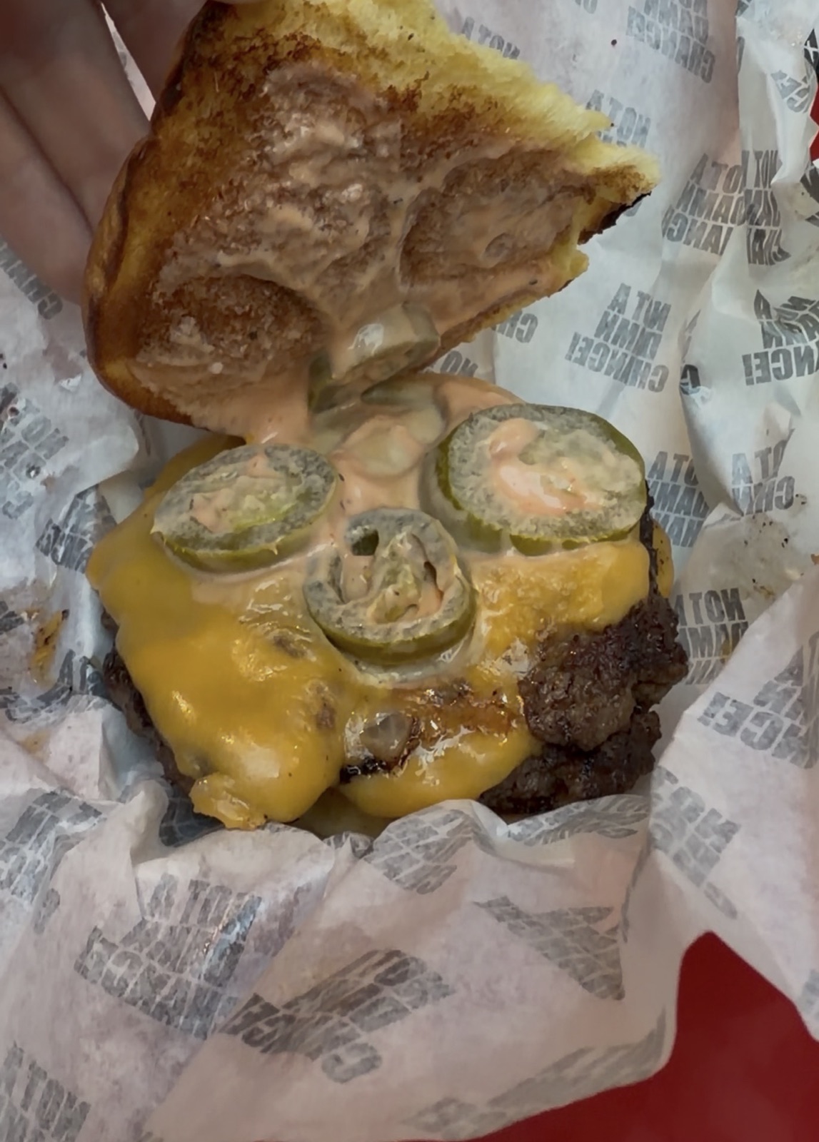 Close-up of the NADC Burger, cheese and pickled jalapenos