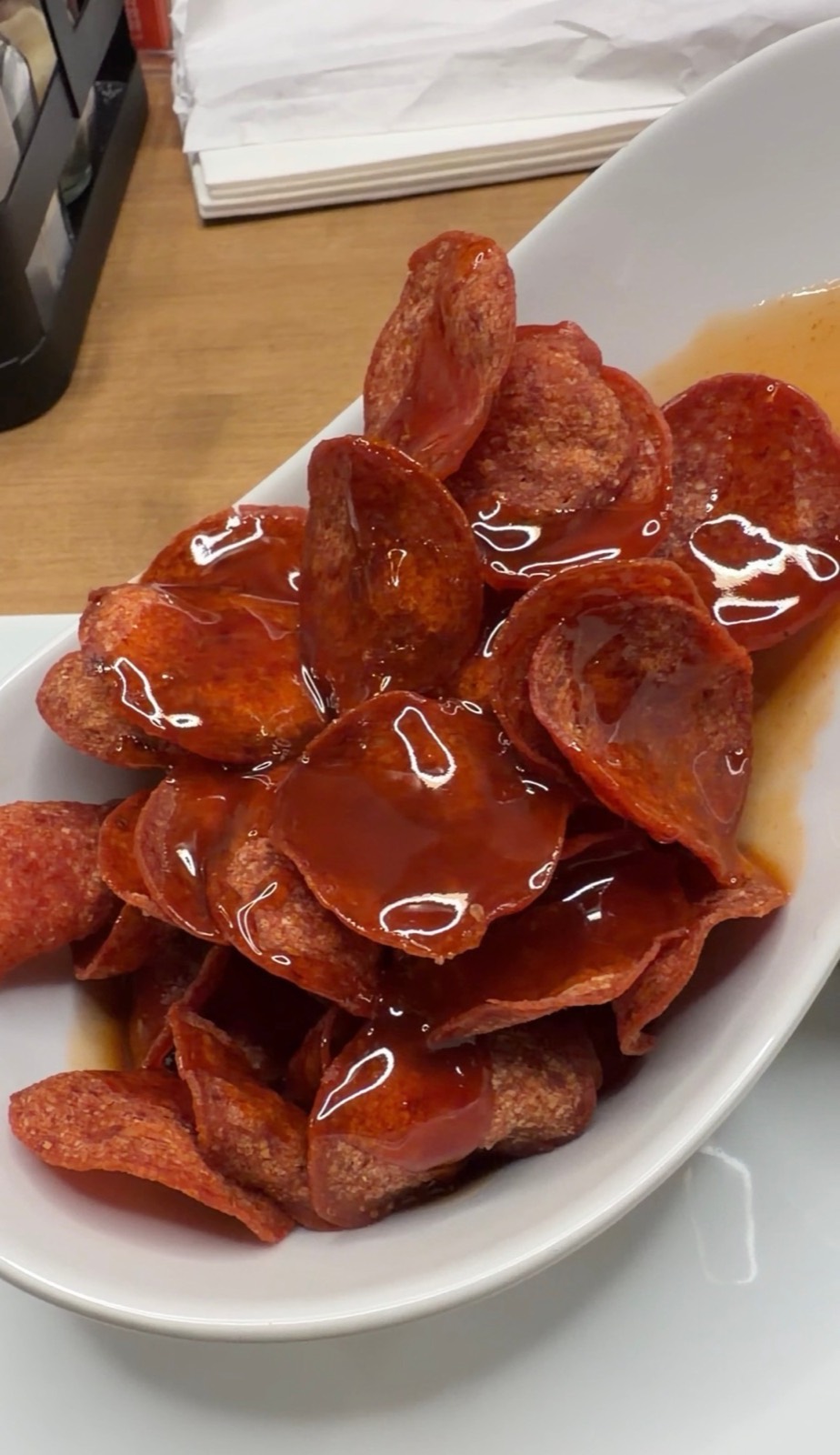 Sam's order: crisped Pepperoni Chips drizzled with hot honey on a white plate