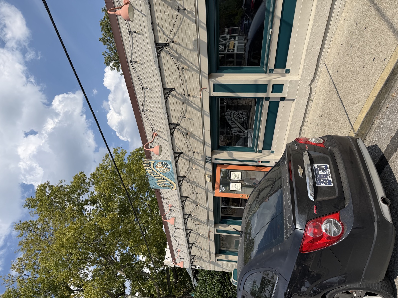 The Pharmacy Burger Parlor exterior on McFerrin Avenue, with a hanging sign and string lights over the windows