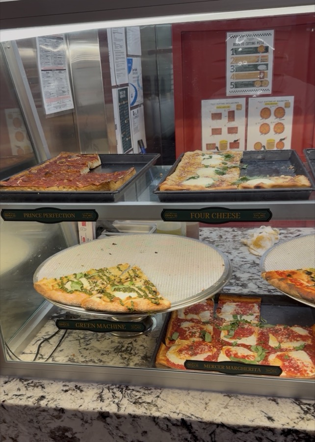Prince St. Pizza's display case with fresh square slices, Nashville
