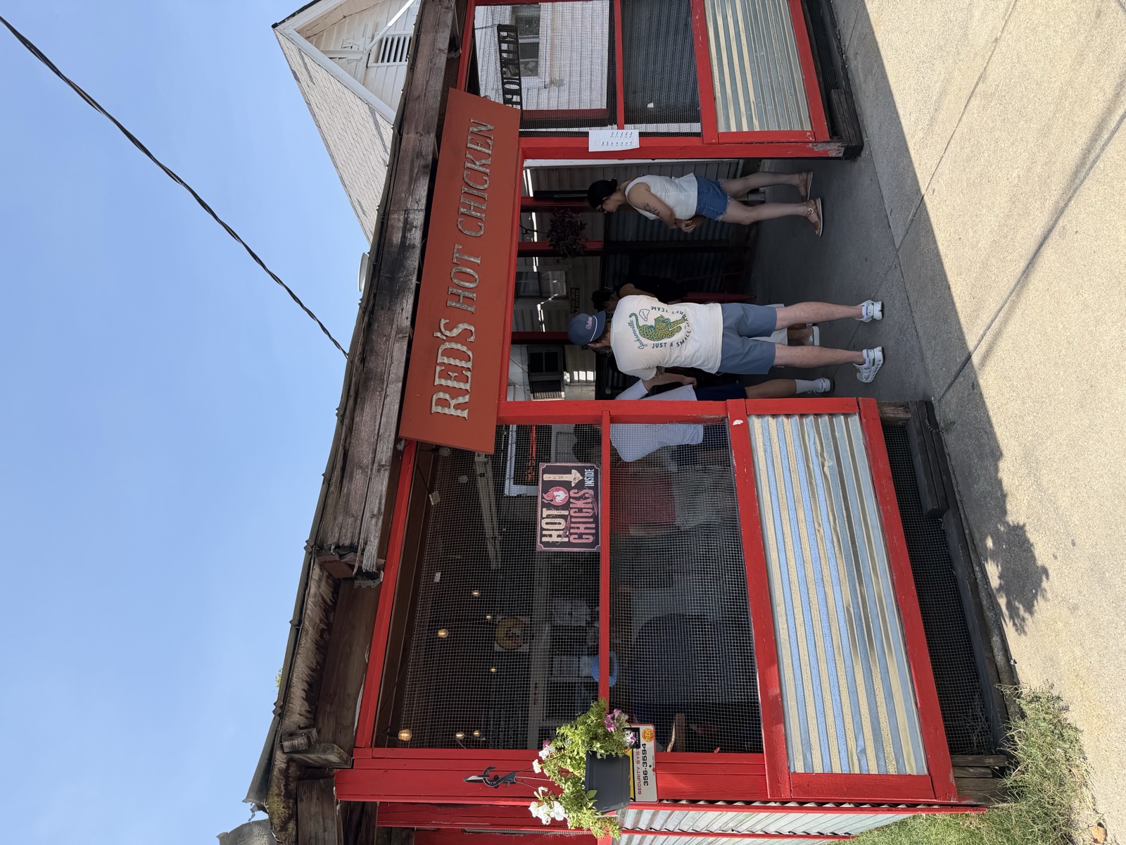 Red's Hot Chicken order window and menu board