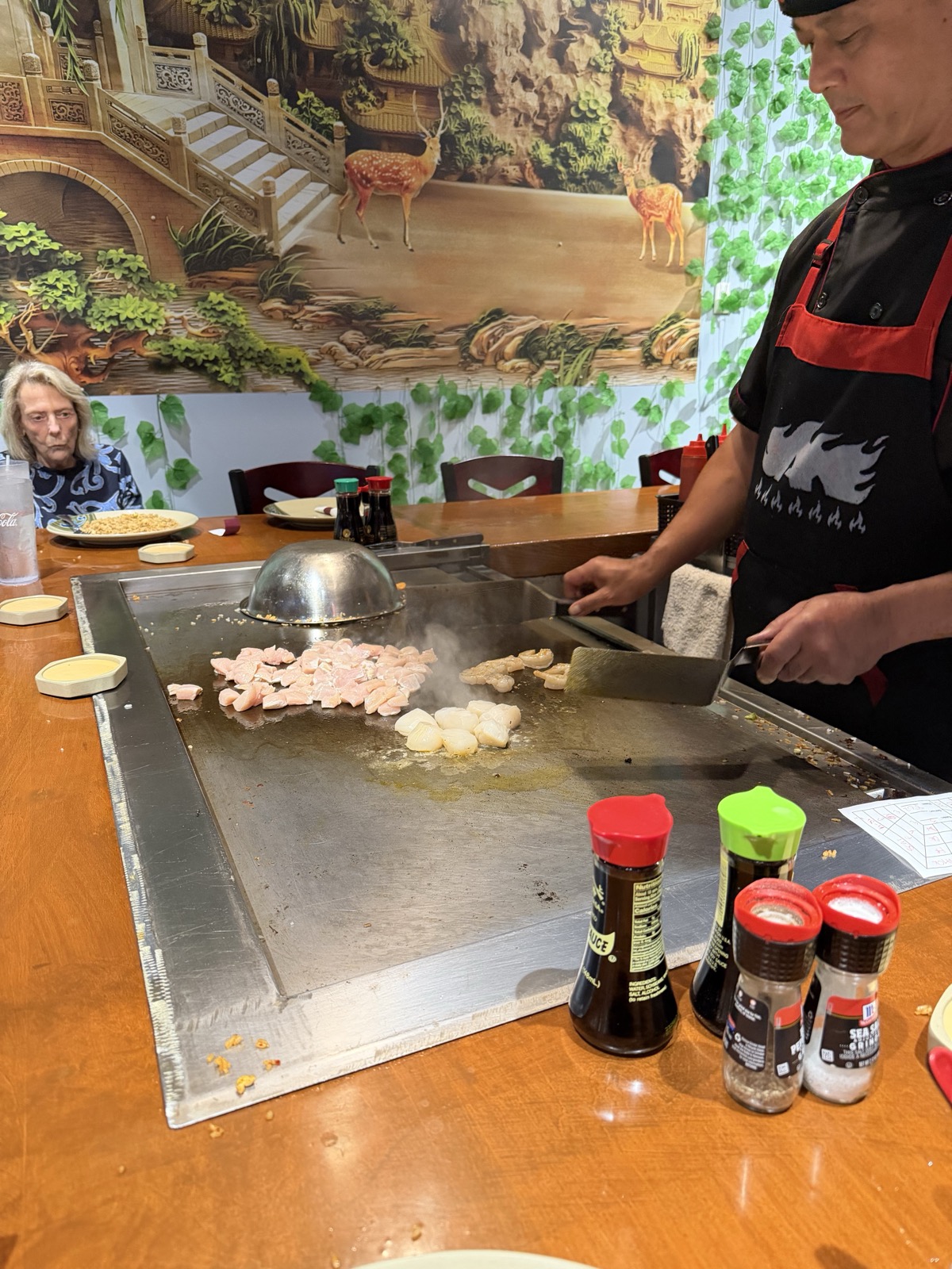 Hibachi chef cooking on the grill at Sake Steak House