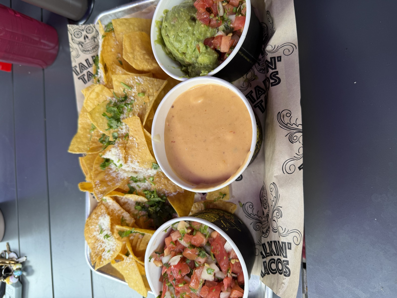 Sam's order: the App Trio, a tray of chips with pico de gallo, queso and guacamole