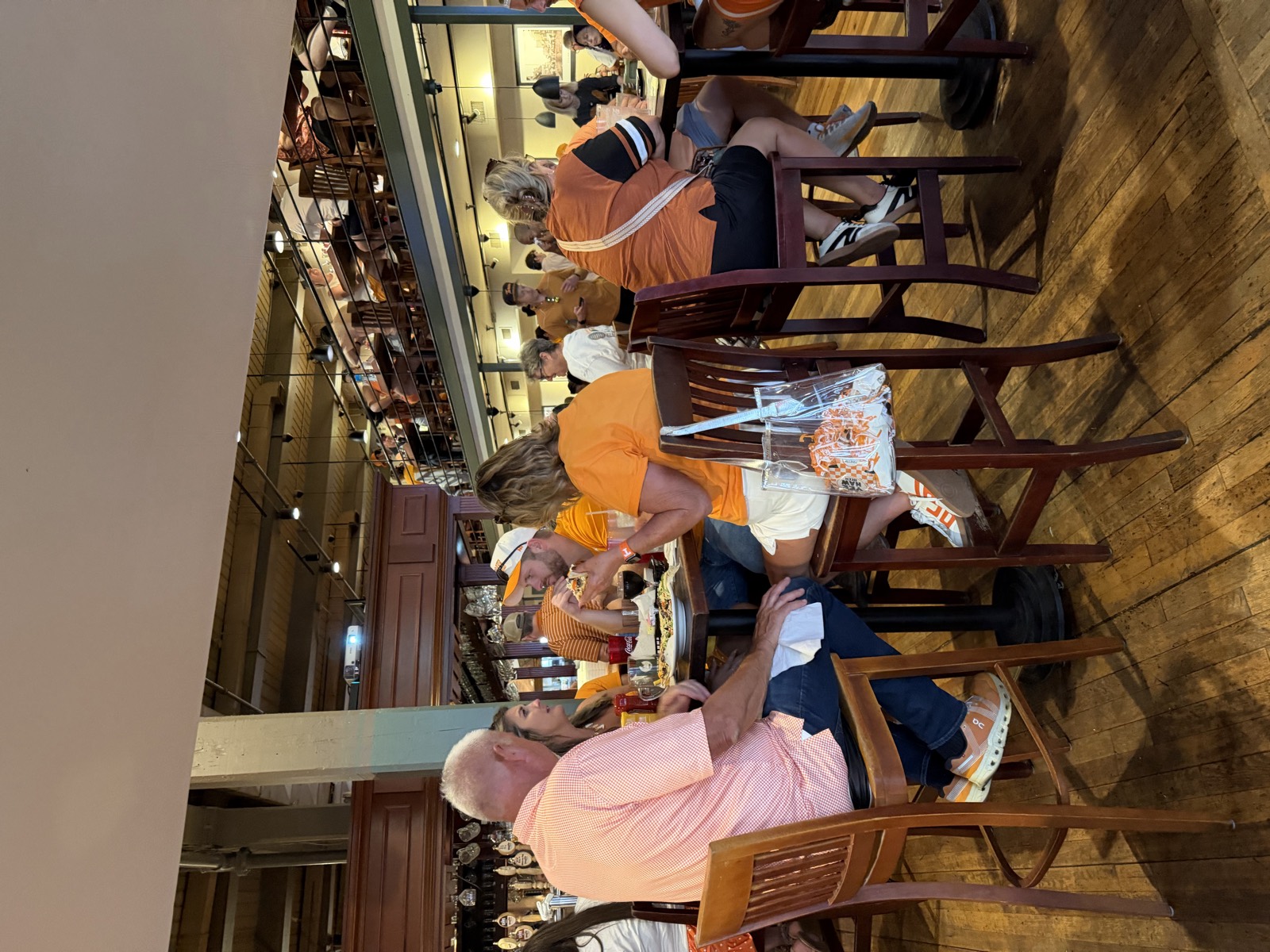 Inside Woodruff's, a packed two-level dining room with wood floors and a balcony above the main floor