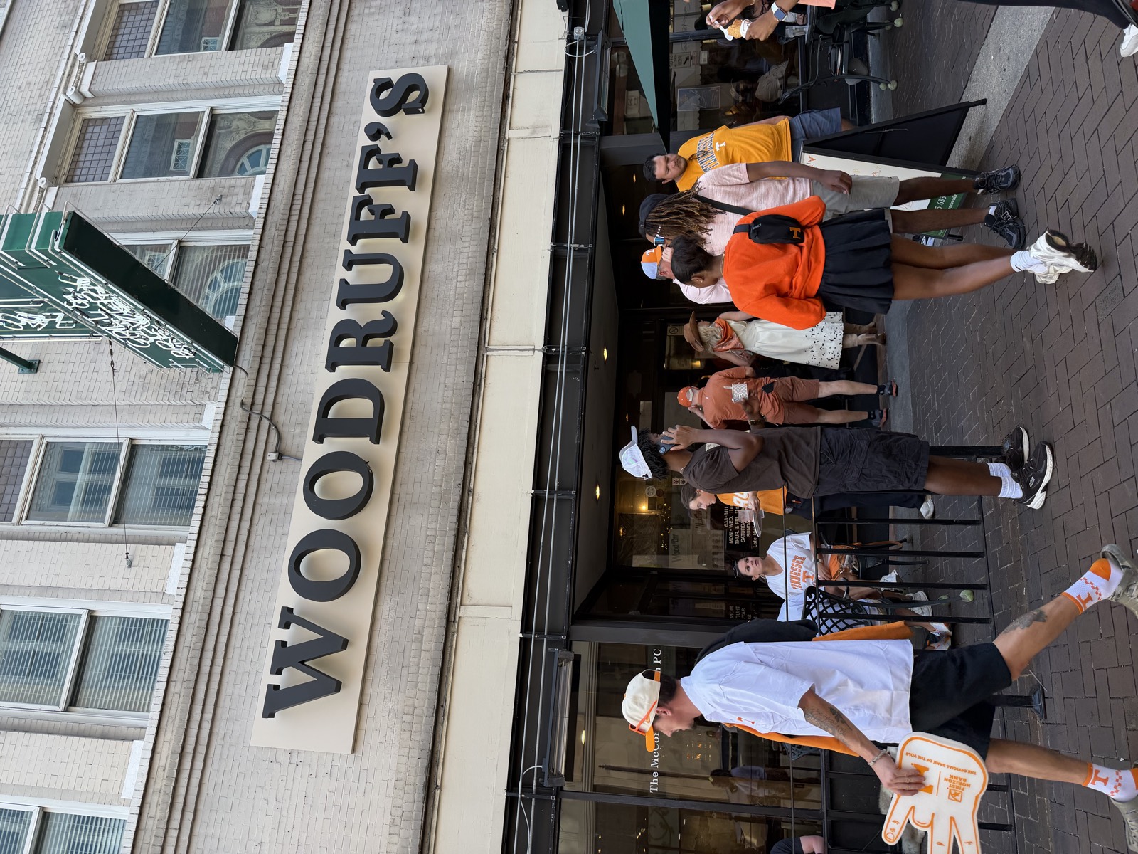 The Woodruff's sign above the entrance on Gay Street, with a crowd in Tennessee orange out front on game day